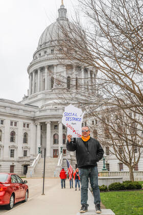 April 24, 2020, Madison, WI, USA: MADISON, WI - April 24: At a Rally to Reopen Wisconsin , a lone protester demonstrates against measures enacted to mitigate the corona virus on April 24, 2020 at the Wisconsin state Capitol in Madison, WI. ( Icon Sportswire) Madison USA - ZUMAi88_ 20200424_zaf_i88_024 Copyright: xLawrencexIlesx