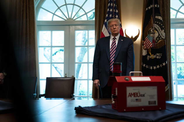 April 24, 2020, Washington, District of Columbia, USA: United States President Donald J. Trump looks at AMBUstat, a decontaminator device during a presentation from NASA leadership on their COVID-19 response in the Cabinet Room of the White House in Washington DC on April 24th, 2020 Washington USA - ZUMAs152 20200424_zaa_s152_064 Copyright: xAnnaxMoneymakerx