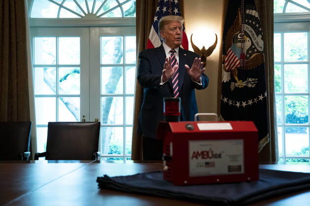 April 24, 2020, Washington, District of Columbia, USA: United States President Donald J. Trump gestures towards AMBUstat, a decontaminator device during a presentation from NASA leadership on their COVID-19 response in the Cabinet Room of the White House in Washington DC on April 24th, 2020 Washington USA - ZUMAs152 20200424_zaa_s152_065 Copyright: xAnnaxMoneymakerx