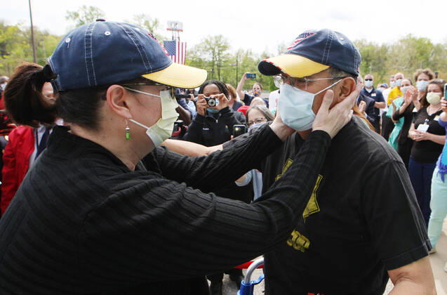 St. Louis Metropolitan motorcycle Police Officer Dave Tenorio is greeted by his emotional wife Kathy for the first time, during a celebration discharge, at St. Luke s Hospital, in Chesterfield, Missouri on Friday, April 24, 2020. After being admitted on April 1,Tenorio is St. Luke s first COVID-19 patient to be treated with ECMO (extracorporeal membrane oxygenation) and is the first known COVID-19 patient in the St. Louis region to be treated with ECMO and be released. ECMO acts as an outside heart and lung to support the body when a person s own organs are too sick to do the job. It extracts blood, adds oxygen and pumps blood back into the body.  SLP2020042402 BILLxGREENBLATT