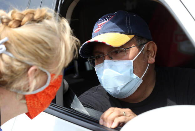 St. Louis Metropolitan motorcycle Police Officer Dave Tenorio says goodby to a nurse during a celebration discharge, at St. Luke s Hospital, in Chesterfield, Missouri on Friday, April 24, 2020. After being admitted on April 1,Tenorio is St. Luke s first COVID-19 patient to be treated with ECMO (extracorporeal membrane oxygenation) and is the first known COVID-19 patient in the St. Louis region to be treated with ECMO and be released. ECMO acts as an outside heart and lung to support the body when a person?s own organs are too sick to do the job. It extracts blood, adds oxygen and pumps blood back into the body.  SLP2020042403 BILLxGREENBLATT