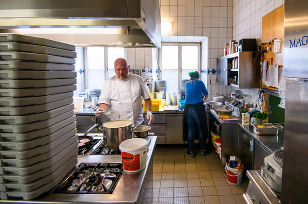 (200425) -- ROSENHEIM, April 25, 2020 (Xinhua) -- Michael Haldek (L) and Christine Haldek, owners of restaurant Fischkueche, prepare free meals in the kitchen of the restaurant in Rosenheim, southern Germany, April 24, 2020. As the COVID-19 hit southern German city Rosenheim, Fischkueche (Fish Kitchen), a restaurant with a history of more than 100 years, has provided nearly 2,000 free meals with free delivery by volunteers to local people needing help in recent five weeks. (Photo by Kevin Voigt Xinhua) GERMANY-ROSENHEIM-COVID-19-FREE MEALS
