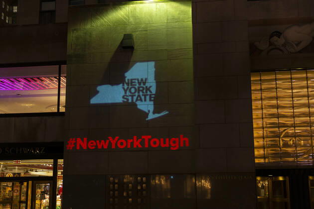Daily life in New York amid COVID-19 pandemic Logo New York Tough hashtag NewYorkTough projected onto wall of Rockefeller Center during COVID-19 pandemic New York New York United States Copyright: LevxRadin