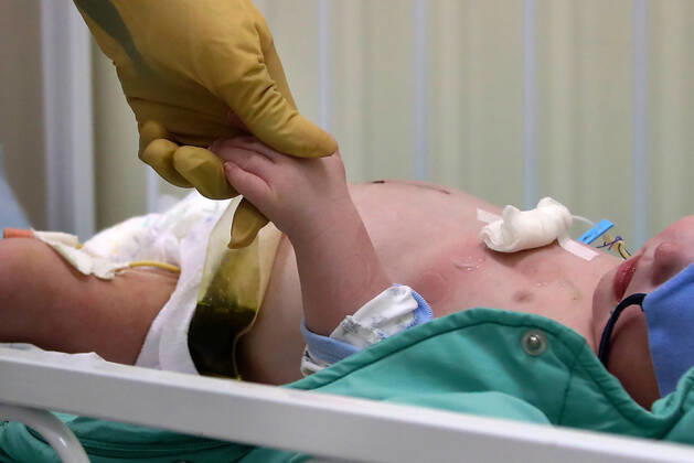 MOSCOW, RUSSIA - APRIL 24, 2020: A medical staff member and a young patient in the centre for infectious diseases, which opened on 20 April 2020 at the National Medical Research Centre for Children s Health (NMITS) to treat young patients with suspected or confirmed novel coronavirus infection (COVID-19). The medical facility has 300 beds, an additional 30 beds in the intensive care unit, and 8 operating rooms. Valery Sharifulin TASS EDITORIAL USE ONLY; NO COMMERCIAL USE; NO ADVERTISING  TS0D7032