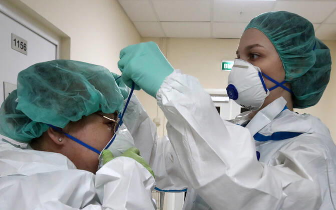MOSCOW, RUSSIA - APRIL 24, 2020: Medical staff members put on protective gear before entering the red zone in the centre for infectious diseases, which opened on 20 April 2020 at the National Medical Research Centre for Children s Health (NMITS) to treat young patients with suspected or confirmed novel coronavirus infection (COVID-19). The medical facility has 300 beds, an additional 30 beds in the intensive care unit, and 8 operating rooms. Valery Sharifulin TASS  TS0D7042