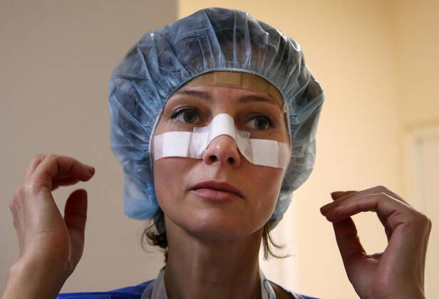 MOSCOW, RUSSIA - APRIL 24, 2020: A medical staff member puts on protective gear before entering the red zone in the centre for infectious diseases, which opened on 20 April 2020 at the National Medical Research Centre for Children s Health (NMITS) to treat young patients with suspected or confirmed novel coronavirus infection (COVID-19). The medical facility has 300 beds, an additional 30 beds in the intensive care unit, and 8 operating rooms. Valery Sharifulin TASS EDITORIAL USE ONLY; NO COMMERCIAL USE; NO ADVERTISING  TS0D7044