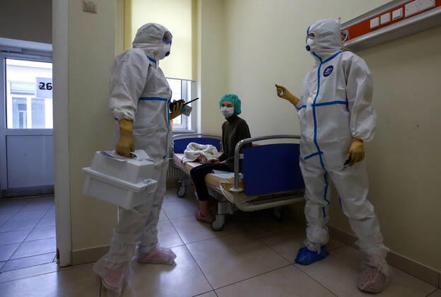 MOSCOW, RUSSIA - APRIL 24, 2020: Medical staff members in protective gear and a patient in the admission ward in the centre for infectious diseases, which opened on 20 April 2020 at the National Medical Research Centre for Children s Health (NMITS) to treat young patients with suspected or confirmed novel coronavirus infection (COVID-19). The medical facility has 300 beds, an additional 30 beds in the intensive care unit, and 8 operating rooms. Valery Sharifulin TASS  TS0D7047