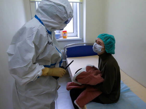 MOSCOW, RUSSIA - APRIL 24, 2020: A medical staff member in protective gear and a patient in the admission ward in the centre for infectious diseases, which opened on 20 April 2020 at the National Medical Research Centre for Children s Health (NMITS) to treat young patients with suspected or confirmed novel coronavirus infection (COVID-19). The medical facility has 300 beds, an additional 30 beds in the intensive care unit, and 8 operating rooms. Valery Sharifulin TASS  TS0D7048