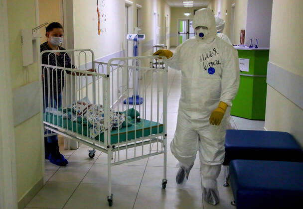 MOSCOW, RUSSIA - APRIL 24, 2020: A medical staff member in protective gear and a young patient with parent in the centre for infectious diseases, which opened on 20 April 2020 at the National Medical Research Centre for Children s Health (NMITS) to treat young patients with suspected or confirmed novel coronavirus infection (COVID-19). The medical facility has 300 beds, an additional 30 beds in the intensive care unit, and 8 operating rooms. Valery Sharifulin TASS  TS0D7053