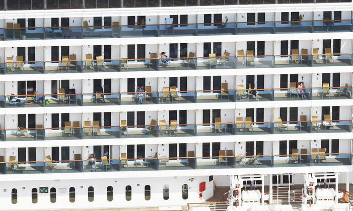 New coronavirus Crew members are seen from a Kyodo News helicopter on the deck of the Costa Atlantica cruise ship anchored in the southwestern Japan city of Nagasaki on April 25, 2020. The Nagasaki prefectural government said the same day that 148 of 623 crew members have so far tested positive for the new coronavirus. 