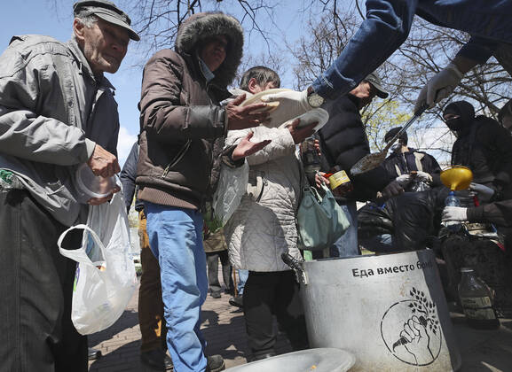 MINSK, BELARUS - APRIL 25, 2020: Volunteers distribute food aid between the homeless in Minsk s Mikhailovsky Garden Square. Natalia Fedosenko TASS  TS0D7108