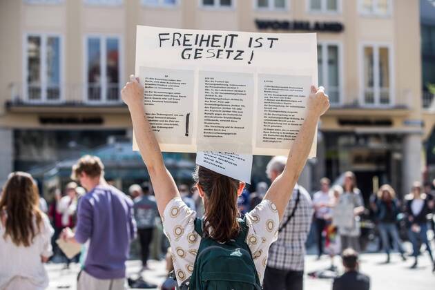 April 25, 2020, Munich, Bavaria, Germany: Freedom is law held up by a demonstrator at a conspiracy theorist demo in Munich, Germany. Organized in Telegram chats by conspiratorial â€oeQuerfront†(cross-front) groups, the city of Munich, Germany saw numerous anti-state â€oeCorona Parties†as under mottos such as â€oeDemonstration fuer die Erhaltung der Grundrechte†(Demonstration for the Upholding of Basic Rights) and â€oeFuer unsere Freiheit, unsere Grundrechte und unsere Selbstbestimmung†(Demonstration for our Freedom, Basic Rights, and Self-Determination). Numerous right-extremists, Verfassungsschutz-monitored figures, QAnon fans, and AfD politicians were in attendance. The groups are of the belief that the anti-Coronavirus measures are power-grabs. Querfront groups are often a mix of politic - ZUMAb160 20200425_zbp_b160_024 Copyright: xSachellexBabbarx