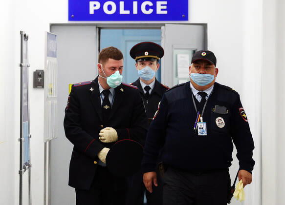 KALININGRAD REGION, RUSSIA - APRIL 25, 2020: Police officers at Kaliningrad s Khrabrovo International Airport ahead of the arrival of the Russian sailors evacuated by an Ural Airlines charter flight from the Spanish port of Las Palmas. On March 27, the Russian government ordered an international flight ban amid the ongoing COVID-19 pandemic, so around 400 Russian sailors, including those 200 from Kaliningrad, found themselves stranded at Gran Canaria Airport. Vitaly Nevar TASS  TS0D713B