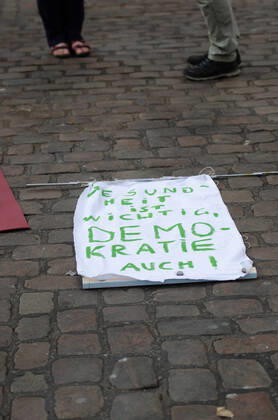 Lockdown beenden sofort! - Demonstration auf dem Südermarkt von Flensburg Die Kommunikationsstelle Demokratischer Widerstand veranstaltet eine Demonstration am 25.04.2020 in Flensburg auf dem Südermarkt, Innenstadt; hier: Transparent mit der Aufschrift Gesundheit ist wichtig, Demokratie auch!