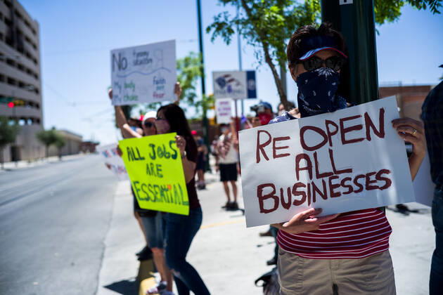 April 25, 2020, El Paso, Texas: BARBARA WAINSCOTT, of El Paso, holds a sign during a Reopen Texas rally in El Paso, Texas. Non-essential personal in El Paso and other cities in Texas continue to remain under stay-at-home orders due to the coronavirus outbreak. El Paso - ZUMAj106 20200425_zap_j106_004 Copyright: xJoelxAngelxJuarezx