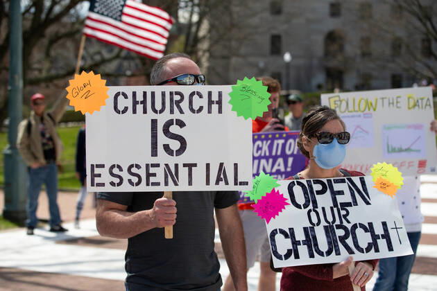 Protesters call on churches to re-open as they gathered for a Rhode Islanders against excessive quarantine protest in reaction to the state s mandatory stay-at-home order as an attempt to combat COVID-19 at the Rhode Island State House in Providence, Rhode Island on Saturday, April 25, 2020. Rhode Island Governor Gina Raimondo has extended the stay-at-home order in an effort to combat the spread of COVID-19 to May 8th and recently told schools that they will finish the year through via distance learning. Rhode Island has had 6,699 confirmed cases of COVID-19 and 202 deaths as of Saturday.  PVD20200425107 MATTHEWxHEALEY