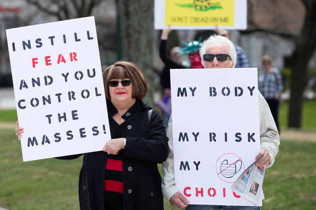 Demonstrators hold signs at a Rhode Islanders against excessive quarantine protest in reaction to the state s mandatory stay-at-home order as an attempt to combat COVID-19 at the Rhode Island State House in Providence, Rhode Island on Saturday, April 25, 2020. Rhode Island Governor Gina Raimondo has extended the stay-at-home order in an effort to combat the spread of COVID-19 to May 8th and recently told schools that they will finish the year through via distance learning. Rhode Island has had 6,699 confirmed cases of COVID-19 and 202 deaths as of Saturday.  PVD20200425108 MATTHEWxHEALEY