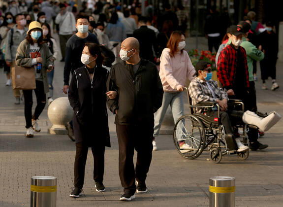 Chinese no longer practice safe social distancing but continue to wear protective face masks while visiting a popular entertainment area even though the government has declared the threat of the Covid-19 outbreak basically finished in Beijing on Sunday, April 26, 2020. As the rest of the world, especially the United States, is wrestling with the deadly novel coronavirus pandemic, daily life in China is gradually returning to normal.  PEK202004260244 STEPHENxSHAVER