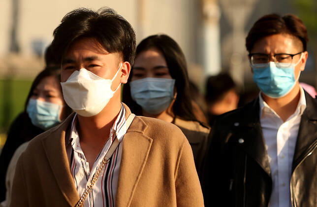 Chinese no longer practice safe social distancing but continue to wear protective face masks while visiting a popular entertainment area even though the government has declared the threat of the Covid-19 outbreak basically finished in Beijing on Sunday, April 26, 2020. As the rest of the world, especially the United States, is wrestling with the deadly novel coronavirus pandemic, daily life in China is gradually returning to normal.  PEK2020042603 STEPHENxSHAVER
