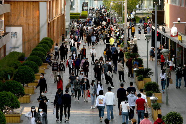 Chinese no longer practice safe social distancing but continue to wear protective face masks while visiting a popular entertainment area even though the government has declared the threat of the Covid-19 outbreak basically finished in Beijing on Sunday, April 26, 2020. As the rest of the world, especially the United States, is wrestling with the deadly novel coronavirus pandemic, daily life in China is gradually returning to normal.  PEK2020042605 STEPHENxSHAVER