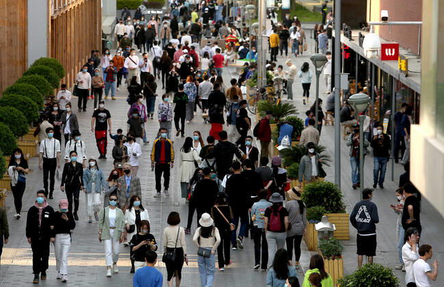 Chinese no longer practice safe social distancing but continue to wear protective face masks while visiting a popular entertainment area even though the government has declared the threat of the Covid-19 outbreak basically finished in Beijing on Sunday, April 26, 2020. As the rest of the world, especially the United States, is wrestling with the deadly novel coronavirus pandemic, daily life in China is gradually returning to normal.  PEK2020042606 STEPHENxSHAVER