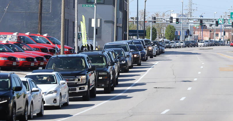 People wait in their cars for blocks for free food, in St. Louis on Sunday, April 26, 2020. Hundreds of cars lined the streets for an opportunity to receive food from several restaurants, while the group took donations for theThe Gateway Resilience Fund, an organization that assists fellow restaurant workers that are out of work because of the coronavirus.  SLP2020042606 BILLxGREENBLATT