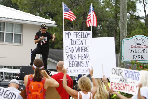 April 26, 2020, Tampa, Florida, USA: Gabriel Aviles speaks to the crowd on top of his vehicle as the official MC of the event. Over 100 supporters of the Re-Open Florida CARavan and Rally movement gathered to protest in front of the FOX 13 News Station on Kennedy on Sunday, April 26, 2020 in Tampa. The group held signs, played music and spread their message to reopen the state of Florida after being closed for months. Tampa USA - ZUMAs70_ 20200426_zan_s70_002 Copyright: xLuisxSantanax