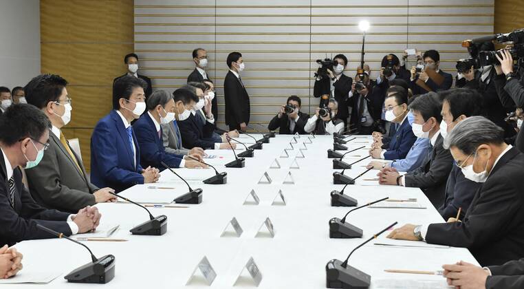 New coronavirus Japanese Prime Minister Shinzo Abe (3rd from L) attends a meeting of the government task force on combatting the new coronavirus pandemic in Tokyo on April 27, 2020. 