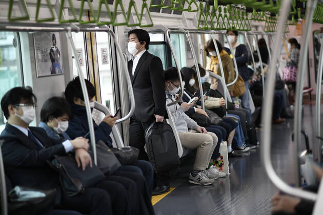 TOKYO, JAPAN - APRIL 27: Commuters wearing face mask head to work early morning during a rush hour in Tokyo amid concerns of the COVID-19 coronavirus on Monday, April 27, 2020. Japanese Prime Minister Shinzo Abe declared a nationwide State of Emergency last week urging people to stay home to prevent the spreading of the coronavirus throughout the country. (Photo: Richard Atrero de Guzman AFLO)  (125743268)