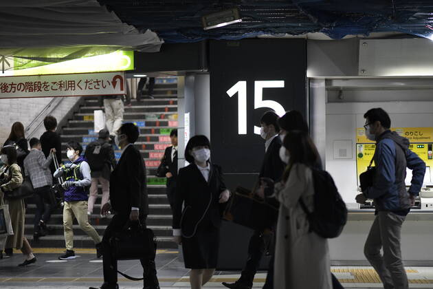 TOKYO, JAPAN - APRIL 27: Commuters wearing face mask head to work early morning during a rush hour in Tokyo amid concerns of the COVID-19 coronavirus on Monday, April 27, 2020. Japanese Prime Minister Shinzo Abe declared a nationwide State of Emergency last week urging people to stay home to prevent the spreading of the coronavirus throughout the country. (Photo: Richard Atrero de Guzman AFLO) (125743314)