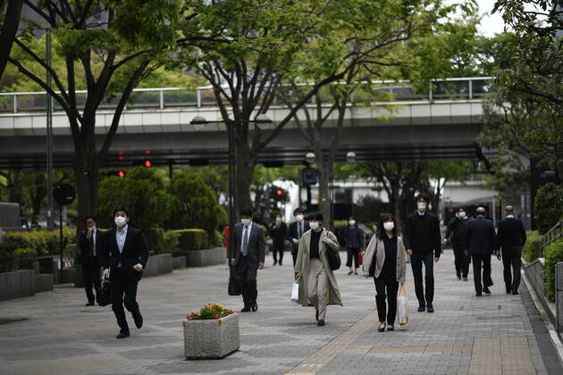 TOKYO, JAPAN - APRIL 27: Commuters wearing face mask head to work early morning during a rush hour in Tokyo amid concerns of the COVID-19 coronavirus on Monday, April 27, 2020. Japanese Prime Minister Shinzo Abe declared a nationwide State of Emergency last week urging people to stay home to prevent the spreading of the coronavirus throughout the country. (Photo: Richard Atrero de Guzman AFLO) (125743338)