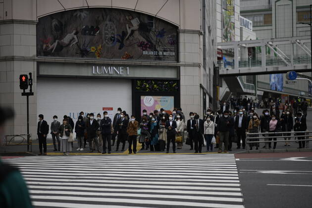 TOKYO, JAPAN - APRIL 27: Commuters wearing face mask head to work early morning during a rush hour in Tokyo amid concerns of the COVID-19 coronavirus on Monday, April 27, 2020. Japanese Prime Minister Shinzo Abe declared a nationwide State of Emergency last week urging people to stay home to prevent the spreading of the coronavirus throughout the country. (Photo: Richard Atrero de Guzman AFLO) (125743370)