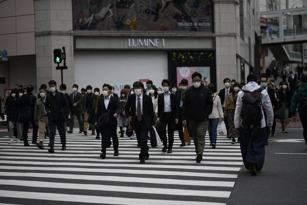 TOKYO, JAPAN - APRIL 27: Commuters wearing face mask head to work early morning during a rush hour in Tokyo amid concerns of the COVID-19 coronavirus on Monday, April 27, 2020. Japanese Prime Minister Shinzo Abe declared a nationwide State of Emergency last week urging people to stay home to prevent the spreading of the coronavirus throughout the country. (Photo: Richard Atrero de Guzman AFLO)  (125743379)