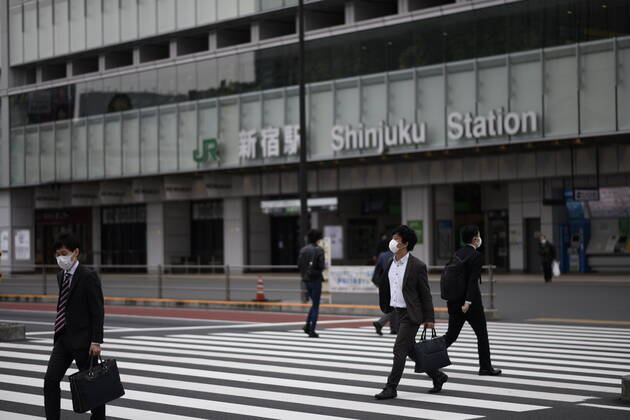 TOKYO, JAPAN - APRIL 27: Commuters wearing face mask head to work early morning during a rush hour in Tokyo amid concerns of the COVID-19 coronavirus on Monday, April 27, 2020. Japanese Prime Minister Shinzo Abe declared a nationwide State of Emergency last week urging people to stay home to prevent the spreading of the coronavirus throughout the country. (Photo: Richard Atrero de Guzman AFLO) (125743387)