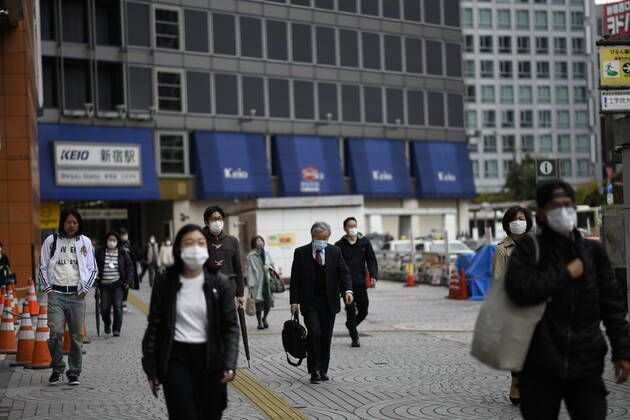 TOKYO, JAPAN - APRIL 27: Commuters wearing face mask head to work early morning during a rush hour in Tokyo amid concerns of the COVID-19 coronavirus on Monday, April 27, 2020. Japanese Prime Minister Shinzo Abe declared a nationwide State of Emergency last week urging people to stay home to prevent the spreading of the coronavirus throughout the country. (Photo: Richard Atrero de Guzman AFLO) (125743417)