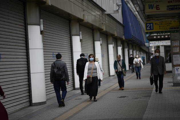TOKYO, JAPAN - APRIL 27: Commuters wearing face mask head to work early morning during a rush hour in Tokyo amid concerns of the COVID-19 coronavirus on Monday, April 27, 2020. Japanese Prime Minister Shinzo Abe declared a nationwide State of Emergency last week urging people to stay home to prevent the spreading of the coronavirus throughout the country. (Photo: Richard Atrero de Guzman AFLO) (125743427)
