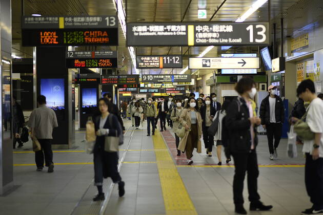 TOKYO, JAPAN - APRIL 27: Commuters wearing face mask head to work early morning during a rush hour in Tokyo amid concerns of the COVID-19 coronavirus on Monday, April 27, 2020. Japanese Prime Minister Shinzo Abe declared a nationwide State of Emergency last week urging people to stay home to prevent the spreading of the coronavirus throughout the country. (Photo: Richard Atrero de Guzman AFLO)  (125743448)