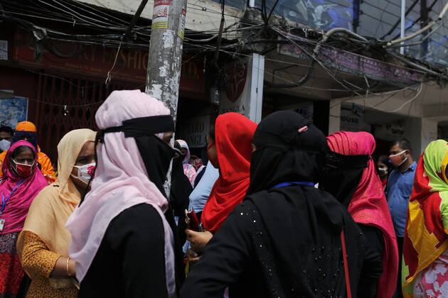 April 27, 2020, Dhaka, Bangladesh: Garment workers gather to join their work in front of a factory near the Banani area during the national-wide lockdown in Dhaka. The factory owner orders them to join the work as they have arrived the factory is still closed. Dhaka Bangladesh - ZUMAh143 20200427_zap_h143_001 Copyright: xMDxMehedixHasanx