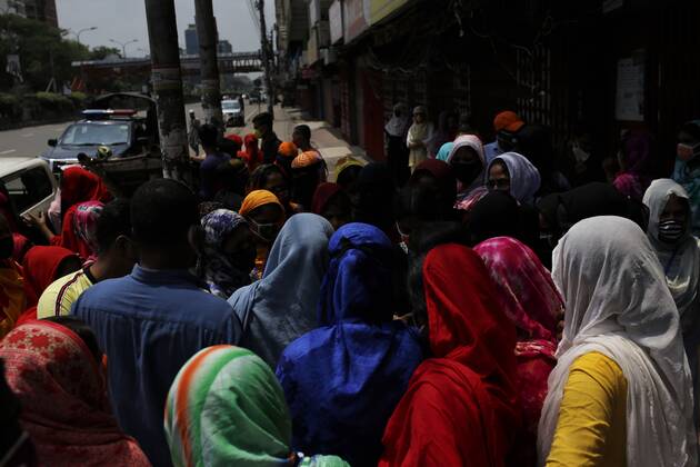 April 27, 2020, Dhaka, Bangladesh: Garment workers gather to join their work in front of a factory near the Banani area during the national-wide lockdown in Dhaka. The factory owner orders them to join the work as they have arrived the factory is still closed. Dhaka Bangladesh - ZUMAh143 20200427_zap_h143_005 Copyright: xMDxMehedixHasanx