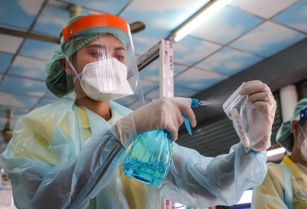 April 27, 2020, Bangkok, Thailand: A health worker wearing gloves as a precaution is seen injecting alcohol which cleans the secretions of patients suspected to be infected with the covid-19 Coronavirus during lab examination..Coronavirus disease (COVID-19) is an infectious disease caused by a newly discovered coronavirus. the virus that causes COVID-19 is mainly transmitted through droplets generated when an infected person coughs, sneezes, or exhales, these droplets are too heavy to hang in the air, and quickly fall on floors or surfaces. Bangkok Thailand - ZUMAs197 20200427_zaa_s197_021 Copyright: xPrawetxPuengsawangpholx
