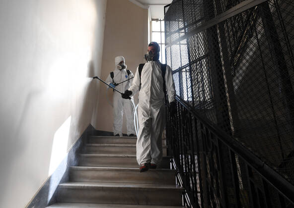 (200427) -- ROME, April 27, 2020 (Xinhua) -- Workers of a disinfection company disinfect a residential building amid the coronavirus pandemic in Rome, Italy, April 27, 2020. (Photo by Alberto Lingria Xinhua) ITALY-ROME-COVID-19-DISINFECTION 