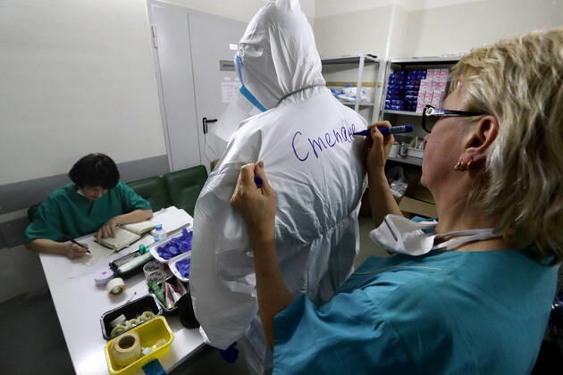 MOSCOW, RUSSIA - APRIL 27, 2020: Writing a doctor s name on protective gear ahead of a shift at the COVID-19 treatment facility at Pirogov City Clinical Hospital 1. The facility treats COVID-19 patients, patients with suspected coronavirus and patients with viral community-acquired pneumonia. Sergei Karpukhin TASS  TS0D73B6