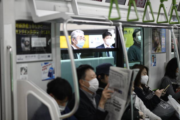 TOKYO, JAPAN - APRIL 28: Commuters wearing face mask head to work during a rush hour in Tokyo amid concerns of the COVID-19 coronavirus outbreak on Tuesday, April 28, 2020. Japanese Prime Minister Shinzo Abe declared a nationwide State of Emergency last week urging people to stay home to prevent the spread of the coronavirus throughout the country. (Photo: Richard Atrero de Guzman AFLO) (125774079)