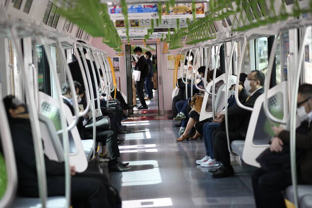 TOKYO, JAPAN - APRIL 28: Commuters wearing face mask head to work during a rush hour in Tokyo amid concerns of the COVID-19 coronavirus outbreak on Tuesday, April 28, 2020. Japanese Prime Minister Shinzo Abe declared a nationwide State of Emergency last week urging people to stay home to prevent the spread of the coronavirus throughout the country. (Photo: Richard Atrero de Guzman AFLO) (125774080)