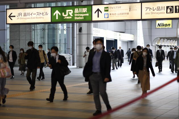 TOKYO, JAPAN - APRIL 28: Commuters wearing face mask head to work during a rush hour in Tokyo amid concerns of the COVID-19 coronavirus outbreak on Tuesday, April 28, 2020. Japanese Prime Minister Shinzo Abe declared a nationwide State of Emergency last week urging people to stay home to prevent the spread of the coronavirus throughout the country. (Photo: Richard Atrero de Guzman AFLO) (125774084)