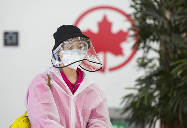 (200427) -- TORONTO, April 27, 2020 -- A traveller wearing protective gear arrives at the Air Canada check-in counters of Pearson International Airport in Toronto, Canada, April 27, 2020. Air Canada suspended all scheduled flights to the United States for four weeks starting on Monday. As of Monday afternoon, there were 48,230 confirmed COVID-19 cases in Canada and 2,701 deaths. (Photo by Xinhua) CANADA-TORONTO-COVID-19-AIR CANADA-FLIGHTS TO U.S.-SUSPENSION ZouxZheng 