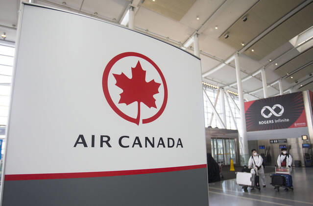 (200427) -- TORONTO, April 27, 2020 -- Travellers wearing protective gears arrive at the Air Canada check-in counters of Pearson International Airport in Toronto, Canada, April 27, 2020. Air Canada suspended all scheduled flights to the United States for four weeks starting on Monday. As of Monday afternoon, there were 48,230 confirmed COVID-19 cases in Canada and 2,701 deaths. (Photo by Xinhua) CANADA-TORONTO-COVID-19-AIR CANADA-FLIGHTS TO U.S.-SUSPENSION ZouxZheng 