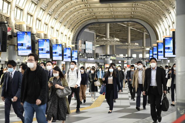 TOKYO, JAPAN - APRIL 28: Commuters wearing face mask head to work during a rush hour in Tokyo amid concerns of the COVID-19 coronavirus outbreak on Tuesday, April 28, 2020. Japanese Prime Minister Shinzo Abe declared a nationwide State of Emergency last week urging people to stay home to prevent the spread of the coronavirus throughout the country. (Photo: Richard Atrero de Guzman AFLO) (125774085)