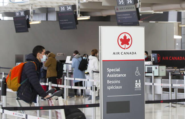 (200427) -- TORONTO, April 27, 2020 -- Travellers check in at the Air Canada counters of Pearson International Airport in Toronto, Canada, April 27, 2020. Air Canada suspended all scheduled flights to the United States for four weeks starting on Monday. As of Monday afternoon, there were 48,230 confirmed COVID-19 cases in Canada and 2,701 deaths. (Photo by Xinhua) CANADA-TORONTO-COVID-19-AIR CANADA-FLIGHTS TO U.S.-SUSPENSION ZouxZheng 