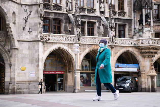 (200428) -- MUNICH, April 28, 2020 (Xinhua) -- A pedestrian wearing a face mask is seen in Munich, Germany, April 27, 2020. In most German states, face masks or an equivalent mouth-and-nose cover have become mandatory on Monday when people travel by bus or train or go shopping. (Photo by Kevin Voigt Xinhua) GERMANY-MUNICH-COVID-19-FACE MASK 